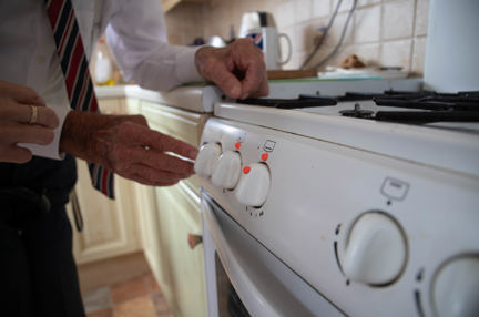 Blind veteran Eddie using an oven marked with bumpons