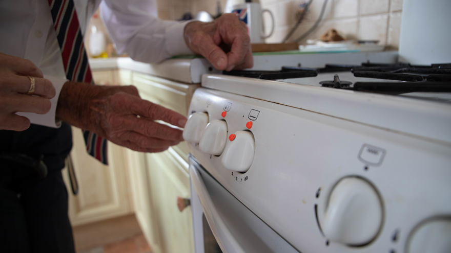 Blind veteran Eddie using an oven marked with bumpons