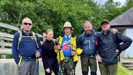 Blind veteran Peter pictured with volunteer Chris, and the rest of his guides after arriving safely back to the visitor centre