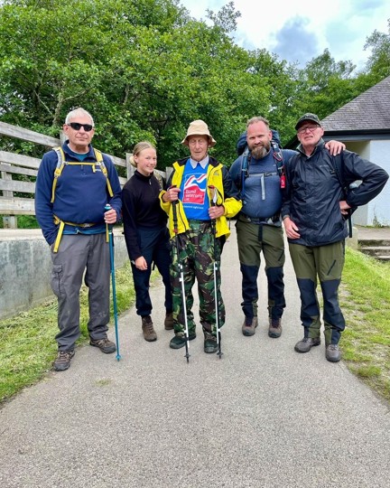 Blind veteran Peter pictured with volunteer Chris, and the rest of his guides after arriving safely back to the visitor centre