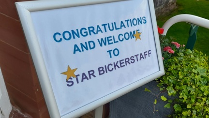 A sign outside our centre of wellbeing displaying gold stars and text that says: Congratulations and welcome to Star Bickerstaff