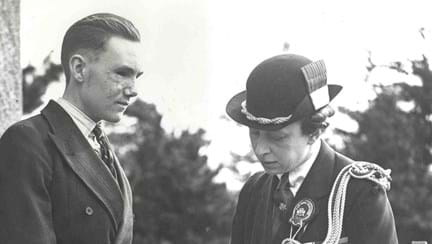 A photo of blind veteran Bill Cowing in 1941, talking to a visiting Princess Mary 