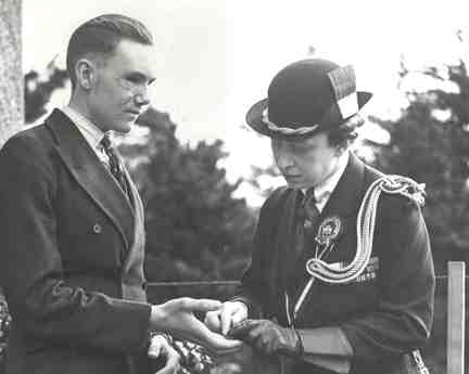 A photo of blind veteran Bill Cowing in 1941, talking to a visiting Princess Mary
