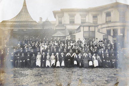 An archive group photograph of blind veterans, nurses and staff outside our headquarters at Regents Park in 1918