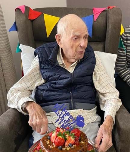 Mike Sadler celebrating his 103rd Birthday with his cake