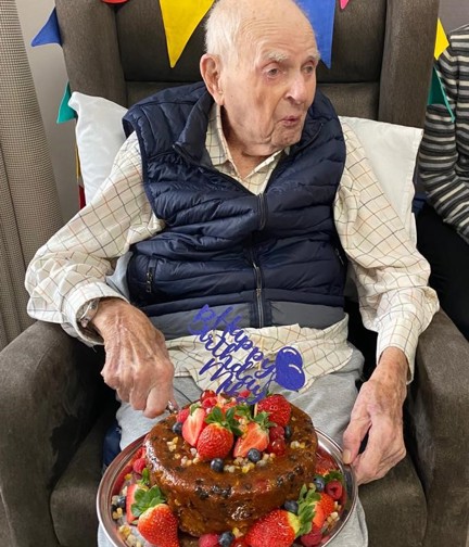 Mike Sadler celebrating his 103rd Birthday with his cake