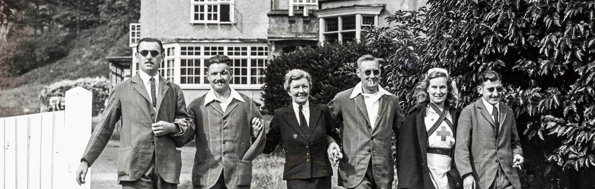 Four blind veterans accompanied by two nurses going for a walk at Church Stretton during World War II