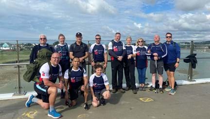 Blind veterans and guides  standing by the sea on their 22 mile walk from Ovingdean to Rustington