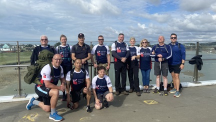 Blind veterans and guides standing by the sea on their 22 mile walk from Ovingdean to Rustington