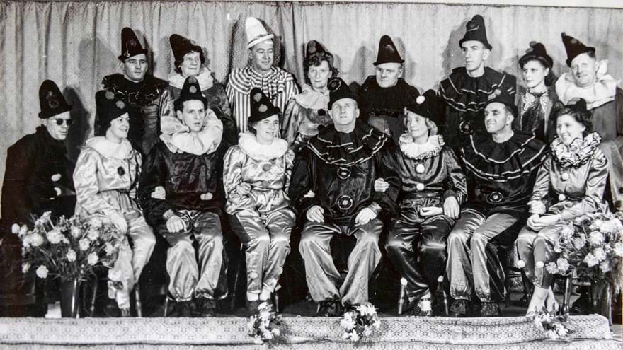 Photo of ensemble theatre cast of blind veterans, with Gwen Obern seated front row, fourth from the left