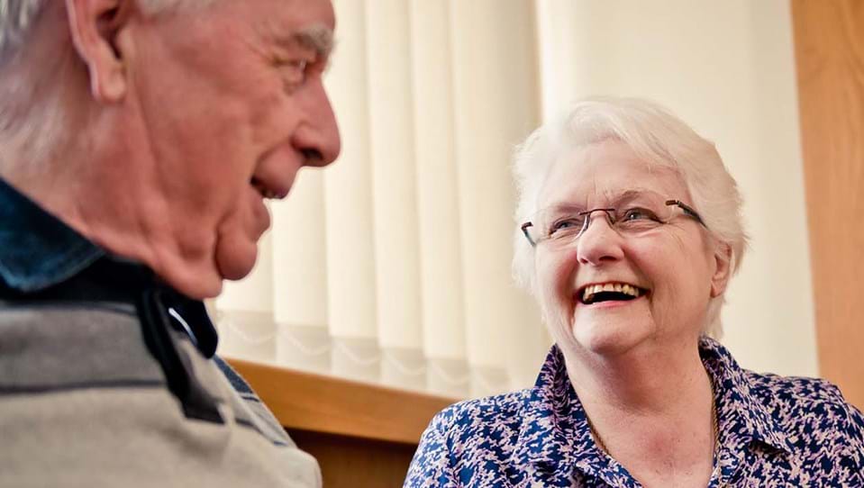 A photo of blind veteran Douglas smiling with another lady