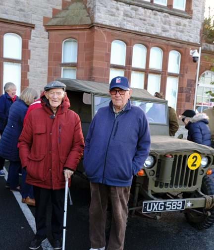 Blind veterans stood in front of a World War Two military vehicle outside the Llandudno Centre of Wellbeing