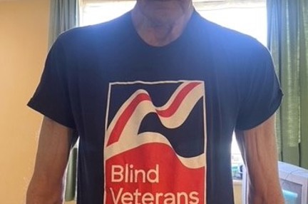 Blind veteran Ron wearing a Blind Veterans UK t-shirt