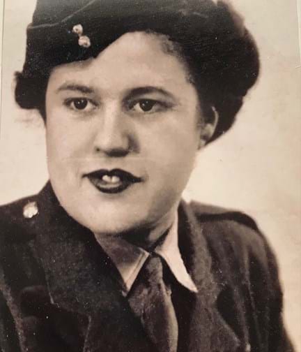 A black and white head-shot of a young Lorna in her Army uniform