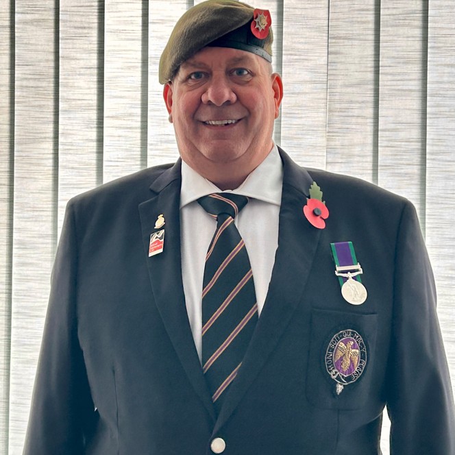 Blind veteran Mark is a navy jacket, tie, medal, and poppy