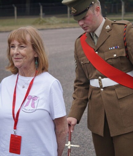 Jennie stands to attention in civilian clothes while being inspected by an Drill Sergeant