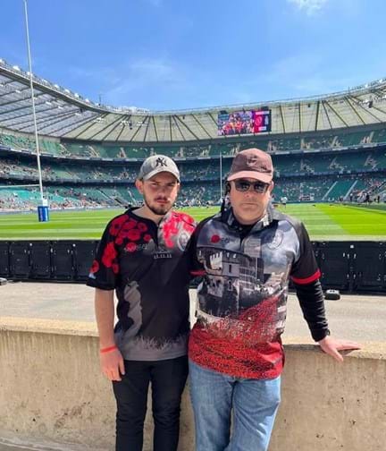 A photo of blind veteran Andy with his son Joe, taken in a stadium