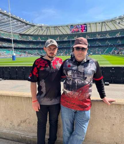 A photo of blind veteran Andy with his son Joe, taken in a stadium