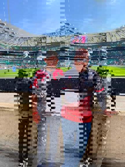 A photo of blind veteran Andy with his son Joe, taken in a stadium