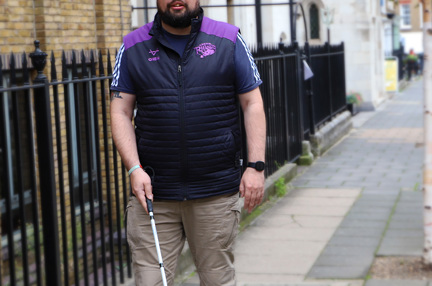 A photo of blind veteran Simon with white cane