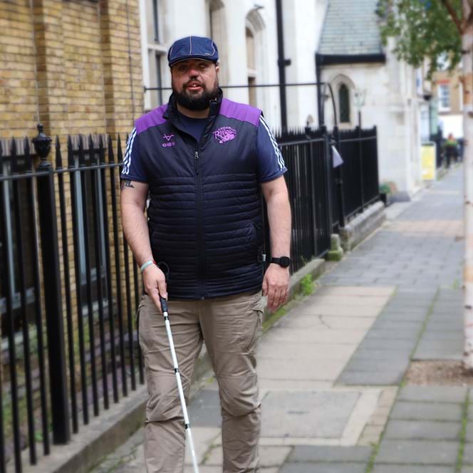 A photo of blind veteran Simon with white cane
