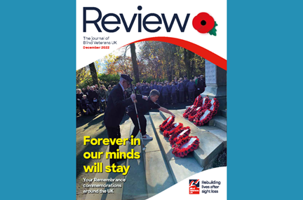 A magazine front cover with title "Forever in our minds will stay" and an image of a blind veteran and young boy laying a wreath at Remembrance