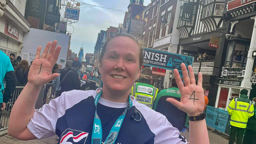 Alison with a huge smile in her Blind Veterans UK vest after finishing the Chester 10k