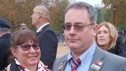 A photo of blind veteran Andrew, right, wearing his military badges