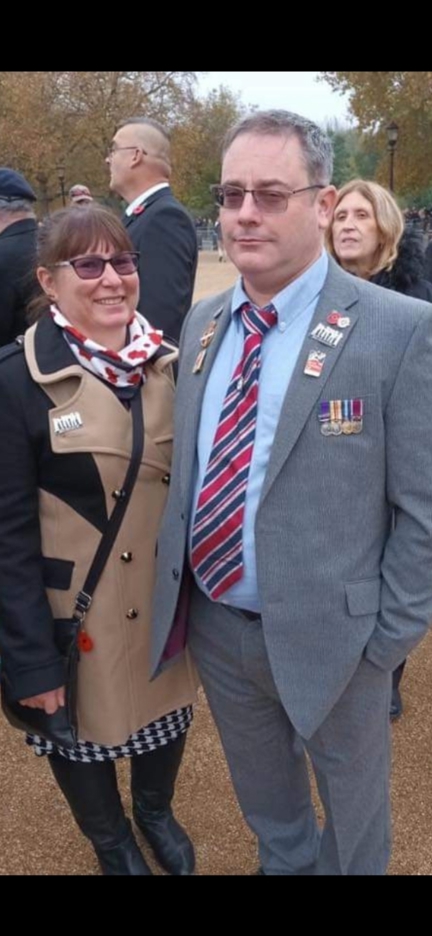 A photo of blind veteran Andrew, right, wearing his military badges