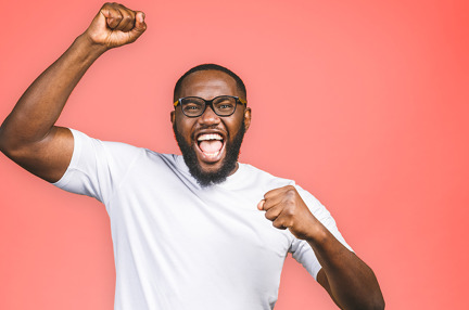 A young man celebrating and cheering with a joyful expression