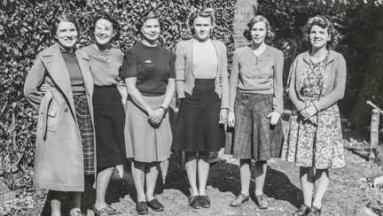 A photo of female munition workers from the 1940s standing together gathered at Church Stretton