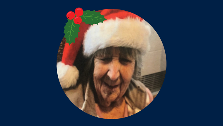 Photo of blind veteran Jean in Christmas hat